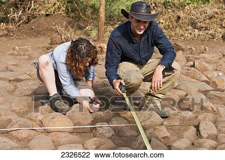South Western Ethiopia, Omo Valley, Southern Mursiland, Archaeologists measuring and labeling stones of benna kulugto; Dirikoro View Large Photo Image Stock Image - South Western Ethiopia, Omo Valley, Southern Mursiland, Archaeologists measuring and labeling stones of benna kulugto; Dirikoro. Fotosearch
