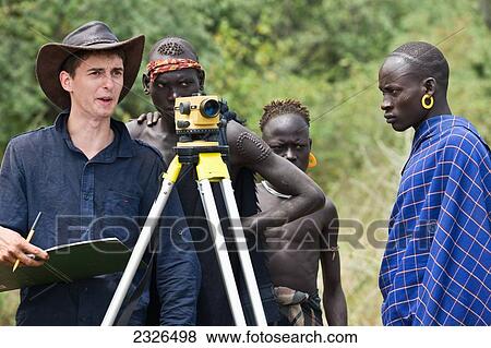 South Western Ethiopia, Omo Valley, Southern Mursiland, Local Mursi warriors with archaeologist; Dirikoro View Large Photo Image Stock Photo - South Western Ethiopia, Omo Valley, Southern Mursiland, Local Mursi warriors with archaeologist; Dirikoro. Fotosearch