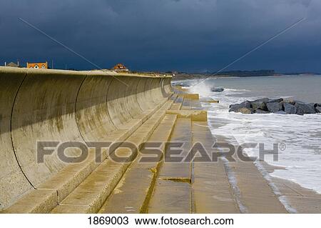 Southwold, Suffolk, England; Concrete Wall Along The Shore Of The North Sea To Break The Waves View Large Photo Image Stock Image - Southwold, Suffolk, England; Concrete Wall Along The Shore Of The North Sea To Break The Waves. Fotosearch