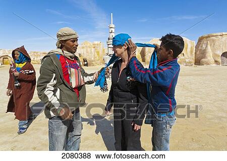 Souvenir Sellers Descend On Tourists Visiting The Old Star Wars Set Mos Espa; Chot El Jerrid, Tunisia, North Africa View Large Photo Image Stock Photo - Souvenir Sellers Descend On Tourists Visiting The Old Star Wars Set Mos Espa; Chot El Jerrid, Tunisia, North Africa. Fotosearch