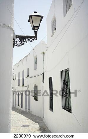 Stock Image - Spain, Andalucia, Costa De La Luz, White Houses And Street Lamp; Vejer De La Frontera. Fotosearch