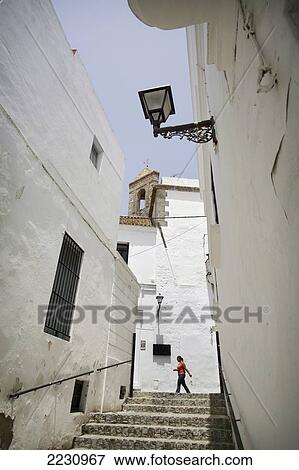 Spain, Andalucia, Costa De La Luz, Church In Background; Vejer De La Frontera, Woman Walking View Large Photo Image Stock Photo - Spain, Andalucia, Costa De La Luz, Church In Background; Vejer De La Frontera, Woman Walking. Fotosearch