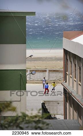 Spain, Andalucia, Costa De La Luz, Children Playing Football By Beach; Tarifa View Large Photo Image Stock Photography - Spain, Andalucia, Costa De La Luz, Children Playing Football By Beach; Tarifa. Fotosearch