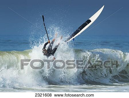 Spain, Andalusia, Cadiz, Costa de la Luz, Tarifa, Falling off paddleboard into water View Large Photo Image Stock Photo - Spain, Andalusia, Cadiz, Costa de la Luz, Tarifa, Falling off paddleboard into water. Fotosearch