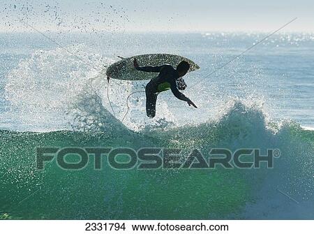 Picture - Spain, Andalusia, Cadiz, Male Surfer Mid Air In Large Splashing Wave; Tarifa. Fotosearch