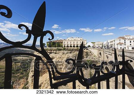Spain, Andalusia, Malaga Province, Ronda, Looking across Tajo gorge to National Parador, Puente Nuevo, or New Bridge, on right View Large Photo Image Stock Image - Spain, Andalusia, Malaga Province, Ronda, Looking across Tajo gorge to National Parador, Puente Nuevo, or New Bridge, on right. Fotosearch