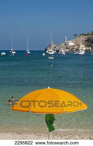 Stock Image - Spain, Beach umbrella on beach of Port Soller; Majorca. Fotosearch