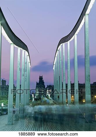 Stock Photo - Spain, Blurred Motion; Barcelona, People Walking Across The Swing Bridge At Dusk. Fotosearch