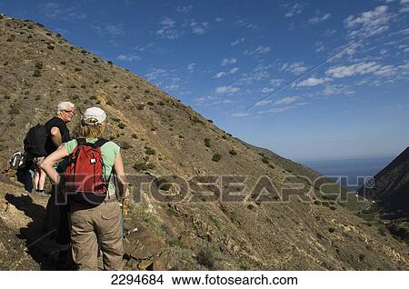 Spain, Canary Islands, Tourist hiking on Vallehermoso trail; Island of La Gomera View Large Photo Image Picture - Spain, Canary Islands, Tourist hiking on Vallehermoso trail; Island of La Gomera. Fotosearch