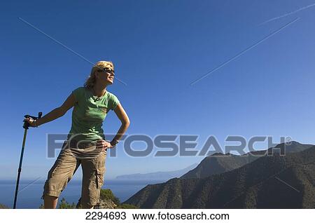 Spain, Canary Islands, Young woman hiking on Vallehermoso trail; Island of La Gomera View Large Photo Image Stock Image - Spain, Canary Islands, Young woman hiking on Vallehermoso trail; Island of La Gomera. Fotosearch