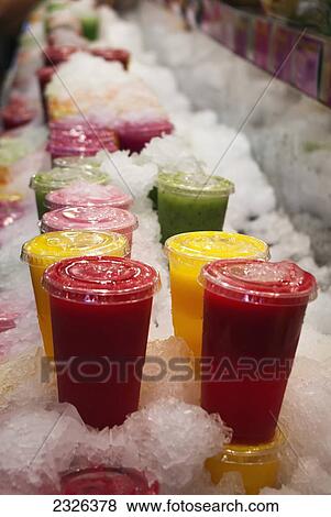 Spain, Catalonia, Cups of fresh fruit juices stacked in crushed ice for sale in La Boqueira; Barcelona View Large Photo Image Stock Photo - Spain, Catalonia, Cups of fresh fruit juices stacked in crushed ice for sale in La Boqueira; Barcelona. Fotosearch