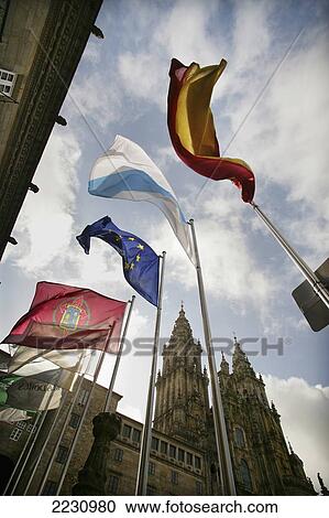 Stock Image - Spain, Galicia, Flags Flying In Front Of Cathedral; Santiago De Compostela. Fotosearch