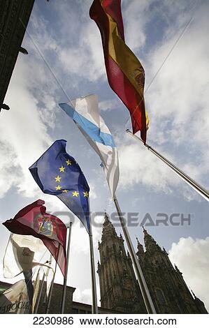 Stock Photograph - Spain, Galicia, Flags Flying In Front Of Cathedral; Santiago De Compostela. Fotosearch