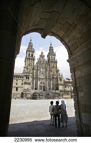 Stock Photography - Spain, Galicia, Tourists Standing In Plaza Marvel At Cathedral; Santiago De Compostela. Fotosearch