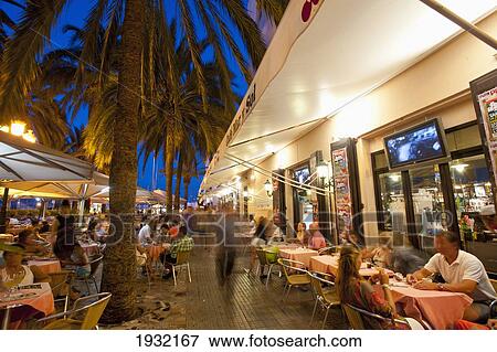 Stock Photo - Spain, Ibiza, Cafes at dusk; Ibiza Town. Fotosearch