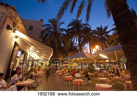Stock Photo - Spain, Ibiza, Cafes at dusk; Ibiza Town. Fotosearch
