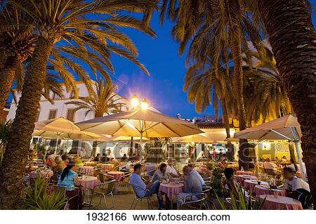 Stock Photograph - Spain, Ibiza, Cafes at dusk; Ibiza Town. Fotosearch