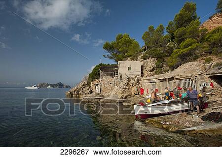 Spain, Ibiza, Fishermen preparing their boat; Cala d'Hort beach View Large Photo Image Stock Photo - Spain, Ibiza, Fishermen preparing their boat; Cala d'Hort beach. Fotosearch