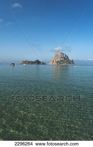 Picture - Spain, Ibiza, Looking out to Es Vedra Island; Cala d'Hort beach. Fotosearch