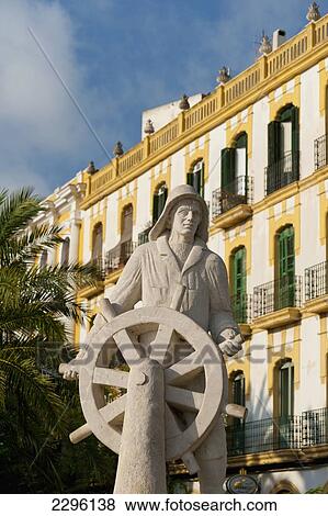 Spain, Ibiza, Statue of sailor at helm in front of old residential building; Ibiza Town View Large Photo Image Stock Photo - Spain, Ibiza, Statue of sailor at helm in front of old residential building; Ibiza Town. Fotosearch