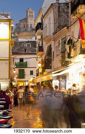Stock Image - Spain, Ibiza, Street at dusk; Ibiza Town. Fotosearch