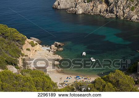 Stock Photo - Spain, Looking down onto Cala d'en Serra beach; Ibiza. Fotosearch