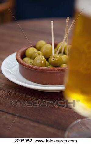 Stock Image - Spain, Majorca, Beer and olives in cafe; Palma. Fotosearch
