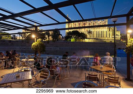 Spain, Majorca, People in cafe beside Parc del Mar with cathedral behind; Palma View Large Photo Image Stock Photo - Spain, Majorca, People in cafe beside Parc del Mar with cathedral behind; Palma. Fotosearch