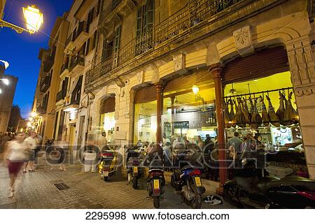 Stock Photo - Spain, Majorca, People in cafes and restaurants at dusk; Palma. Fotosearch