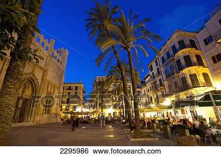 Stock Photograph - Spain, Majorca, People in cafes and restaurants at dusk; Palma. Fotosearch