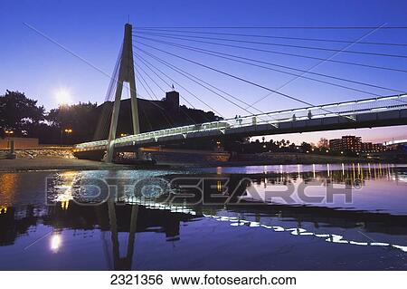 Stock Photograph - Spain, Malaga Province, Costa del Sol, Fuengirola, Footbridge over Sohail river with Sohail castle behind. Fotosearch