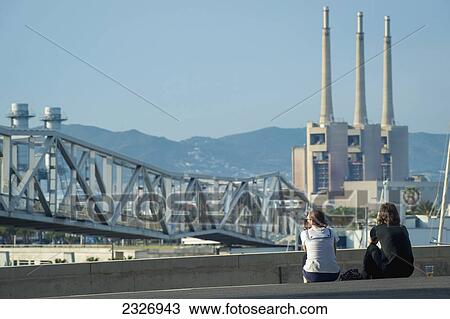 Spain, Parc del Forum; Barcelona, Festival goers enjoying the sun and views of chimneys at Primavera Sound music festival View Large Photo Image Stock Image - Spain, Parc del Forum; Barcelona, Festival goers enjoying the sun and views of chimneys at Primavera Sound music festival. Fotosearch