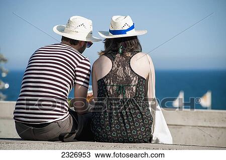 Stock Image - Spain, Parc del Forum; Barcelona, Couple enjoying the view of the sea at Primavera Sound music festival. Fotosearch