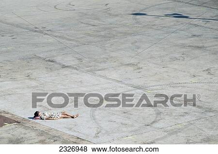 Spain, Parc del Forum; Barcelona, Festival goer relaxing in the sun at Primavera Sound music festival View Large Photo Image Stock Photo - Spain, Parc del Forum; Barcelona, Festival goer relaxing in the sun at Primavera Sound music festival. Fotosearch