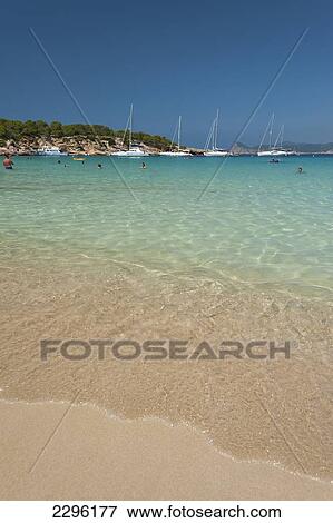 Stock Photo - Spain, People swimming off La Basse beach; Ibiza. Fotosearch
