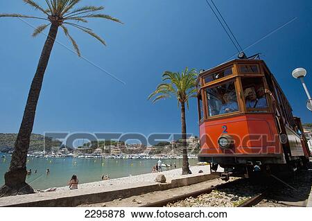 Stock Photo - Spain, Port Soller to Soller tram going past beach of Port Soller; Majorca. Fotosearch