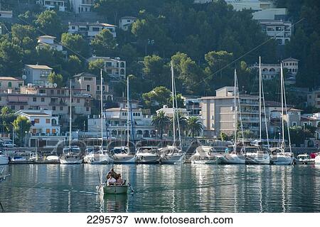Stock Photo - Spain, Small boat going through harbor of Port Soller; Majorca. Fotosearch