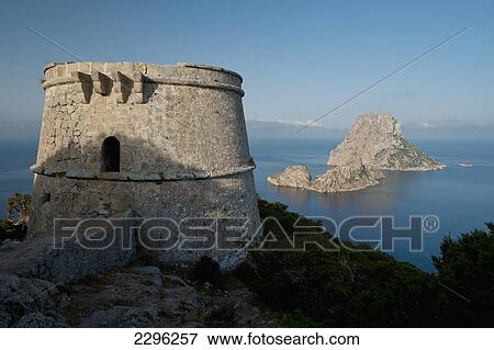 Stock Photo - Spain, Torre des Savinar and Es Vedra island at dawn; Ibiza. Fotosearch