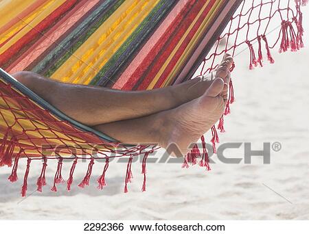 Stock Photograph - Spain, Woman Relaxing In Hammock. Fotosearch