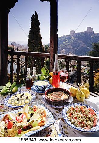 Stock Image - Spanish Food Laid Out On Table On Outdoor Balcony. Fotosearch
