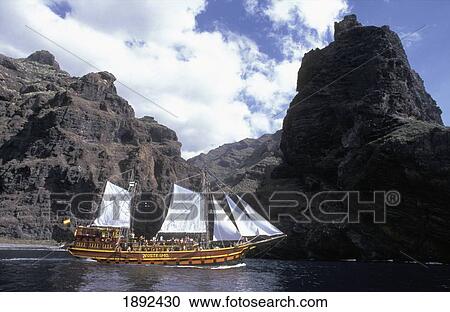 Stock Image - Spanish Tallship Sailing Past Rocky Coast. Fotosearch