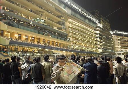 Stock Image - Spectators At Horse Racing Track. Fotosearch