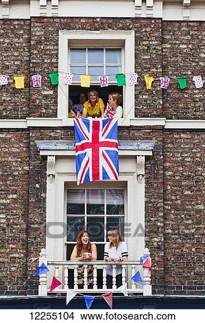 Spectators in windows waiting for the Tour de France; York, England View Large Photo Image Picture - Spectators in windows waiting for the Tour de France; York, England. Fotosearch