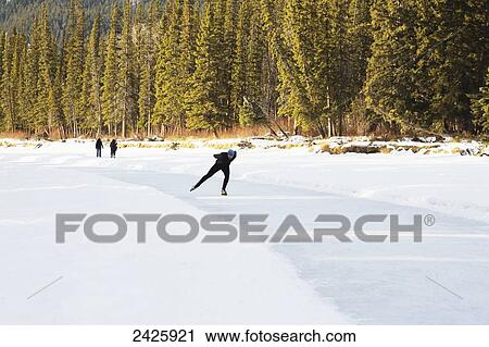 Speed skater practicing on Bow River near Banff; Alberta, Canada View Large Photo Image Stock Image - Speed skater practicing on Bow River near Banff; Alberta, Canada. Fotosearch
