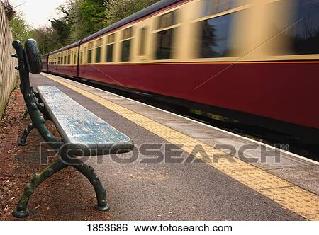 Stock Photograph - Speeding Passenger Train; Yorkshire, England. Fotosearch