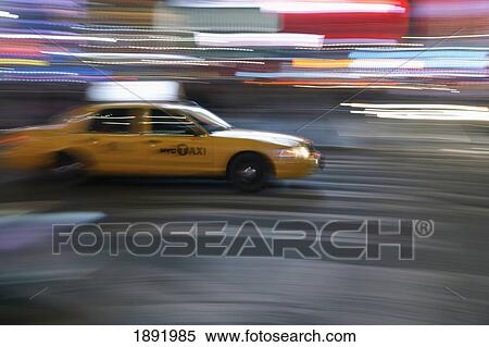 Stock Photography - Speeding Yellow Taxi In Midtown Manhattan. Fotosearch