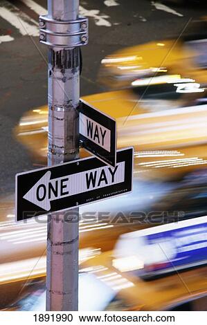 Stock Image - Speeding Yellow Taxis In Times Square. Fotosearch