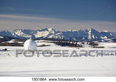 Picture - Spherical Oil Tank In A Snow-Covered Field; Longview, Alberta, Canada. Fotosearch