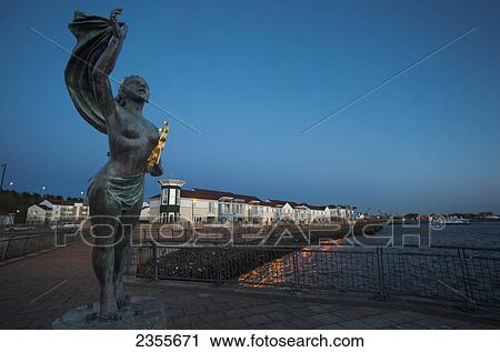 Stock Image - Spirit Of South Shields Statue At Sunset Along The River Tyne; South Shields, Tyne And Wear, England. Fotosearch