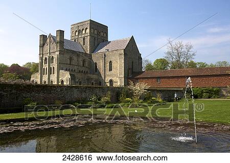 Stock Photograph - St. Cross church and garden; Winchester, Hampshire, England. Fotosearch